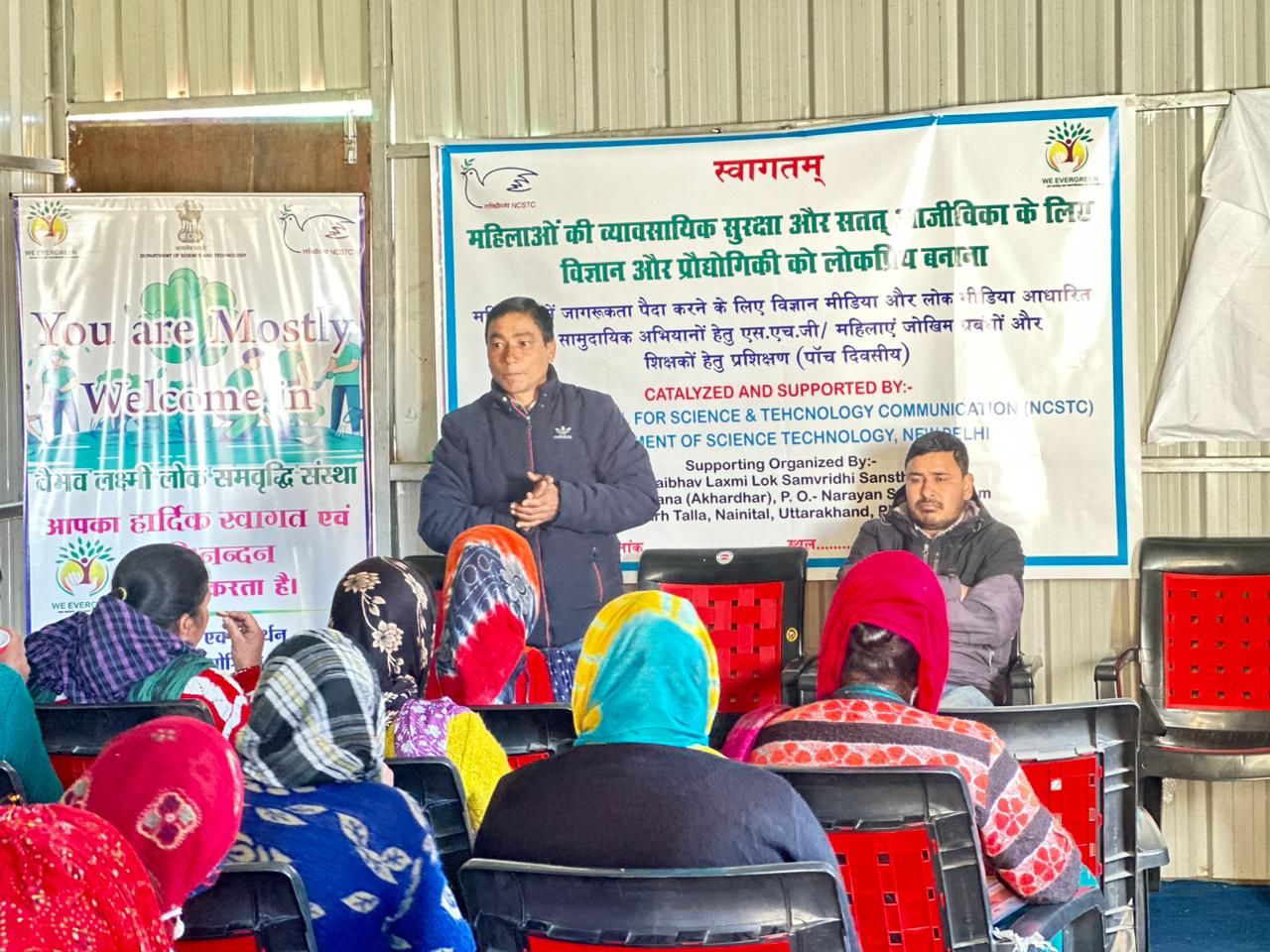 A resource person speaks to women at a workshop on occupational security and sustainable livelihoods.